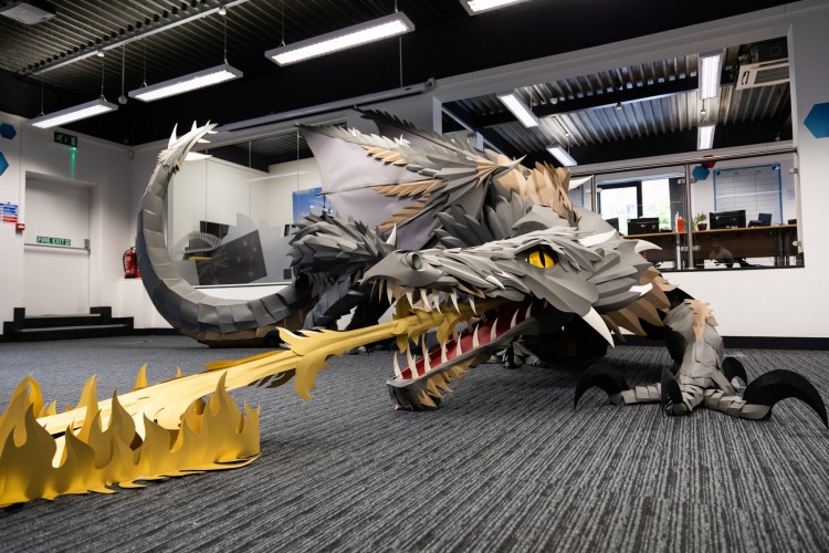 A photo of the paper dragon sculpture by Andy Singleton, installed at Search Laboratory digital marketing agency. The dragon was used as part of a digital PR campaign for Viking, part of Office Depot.